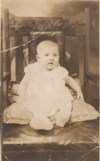 Baby Helen with her Dad holding her in the background